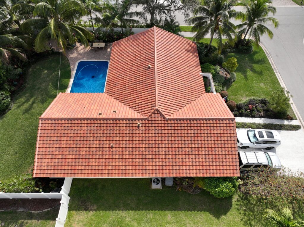 Roof repair of a house with red roof tiles.